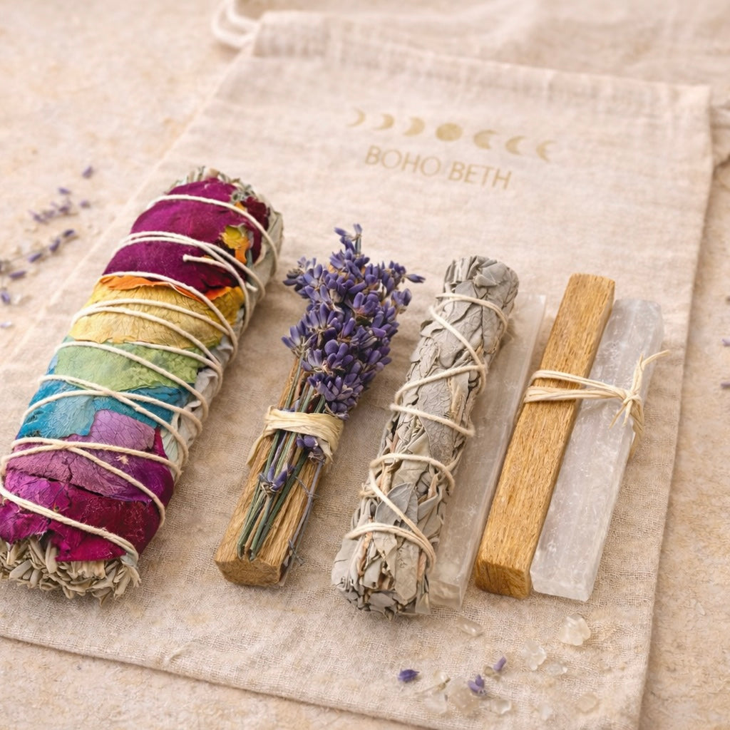 Close up of Boho Beth chakra smudge kit showing chakra sage stick, lavender wand, white sage smudge stick and selenite crystals for chakra energy cleansing