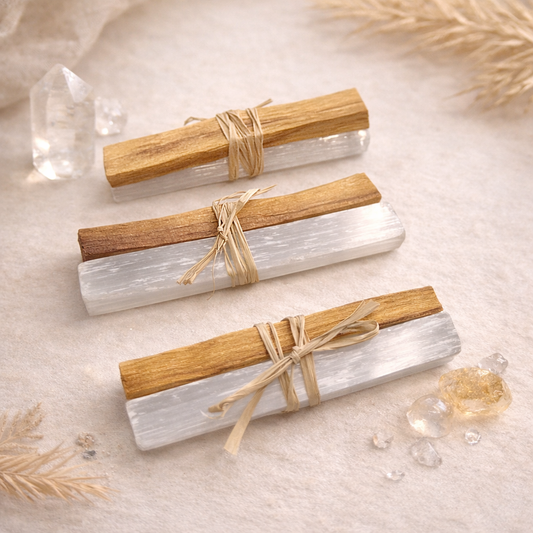 Boho Beth Three cylindrical candles wrapped in wooden sleeves with twine on a textured surface.