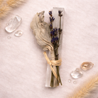 Boho Beth Sage and Selenite dried lavender  tied with twine background with crystals and feathers.