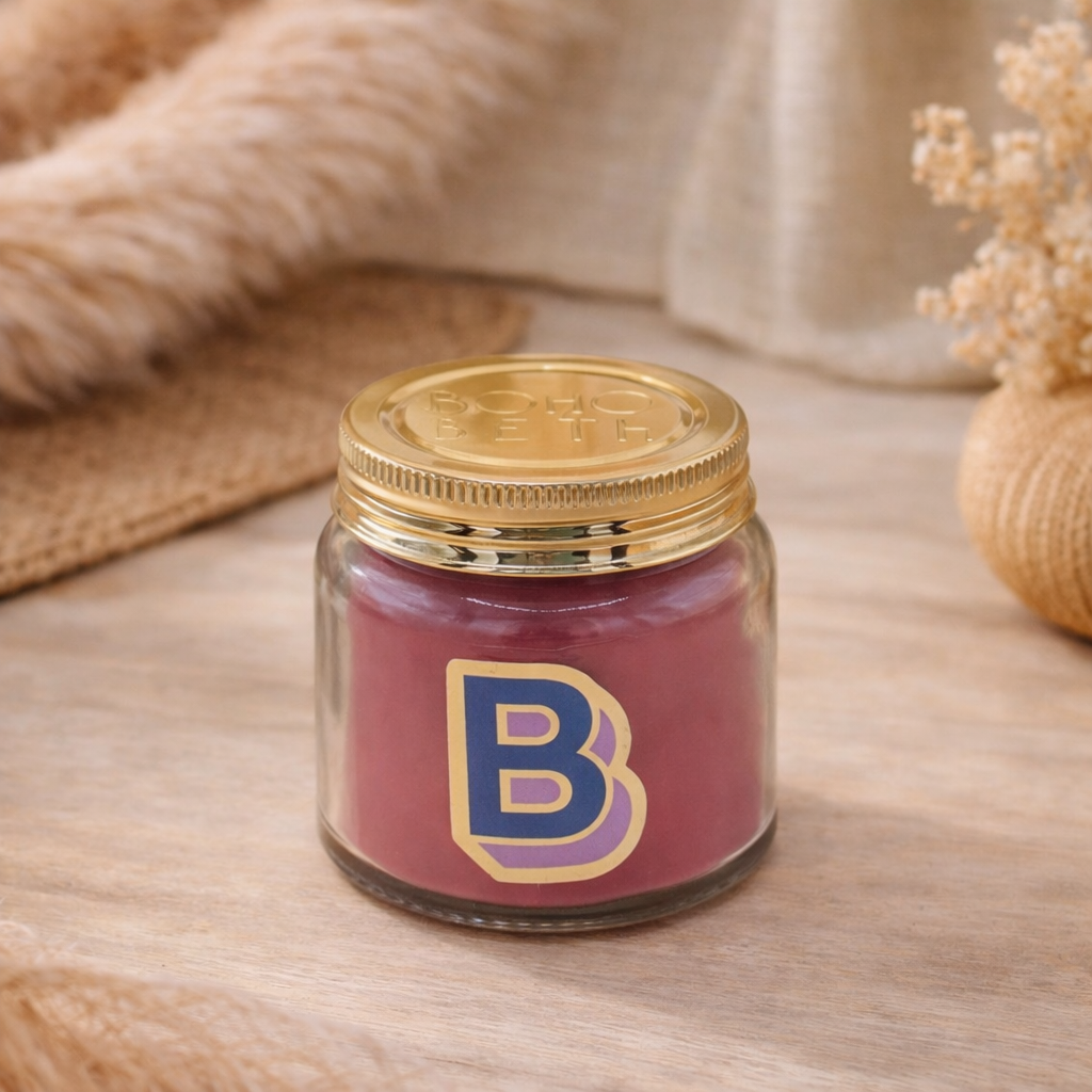 Personalised colour pop letter b candle jar with red wax and gold lid on bohemian background