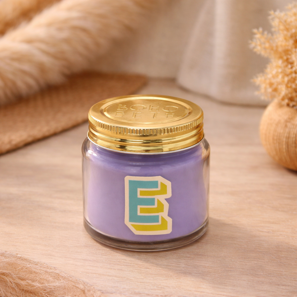 Personalised colour pop letter e candle jar with pastel wax and gold lid on bohemian background