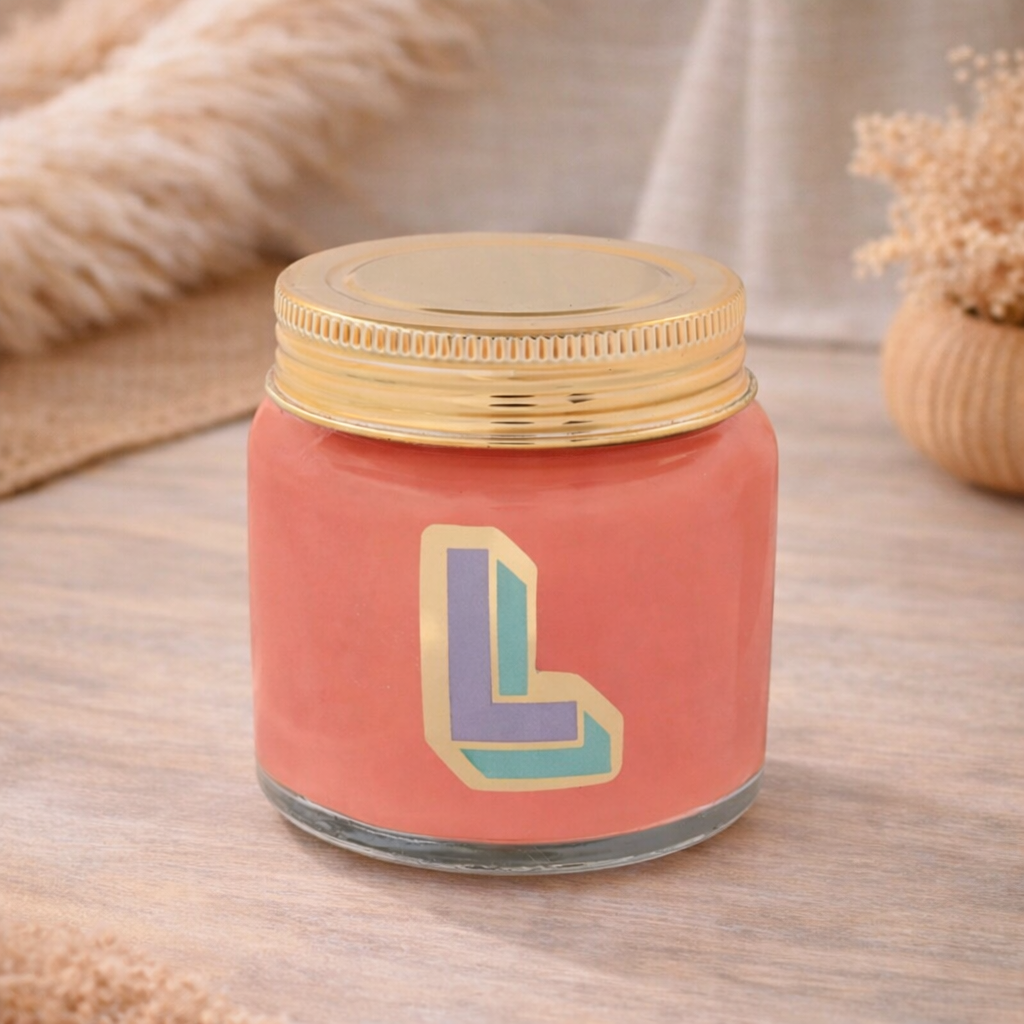 Personalised colour pop letter L candle jar with pastel wax and gold lid on bohemian background