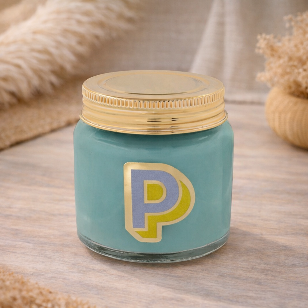 Personalised colour pop letter p candle jar with pastel wax and gold lid on bohemian background