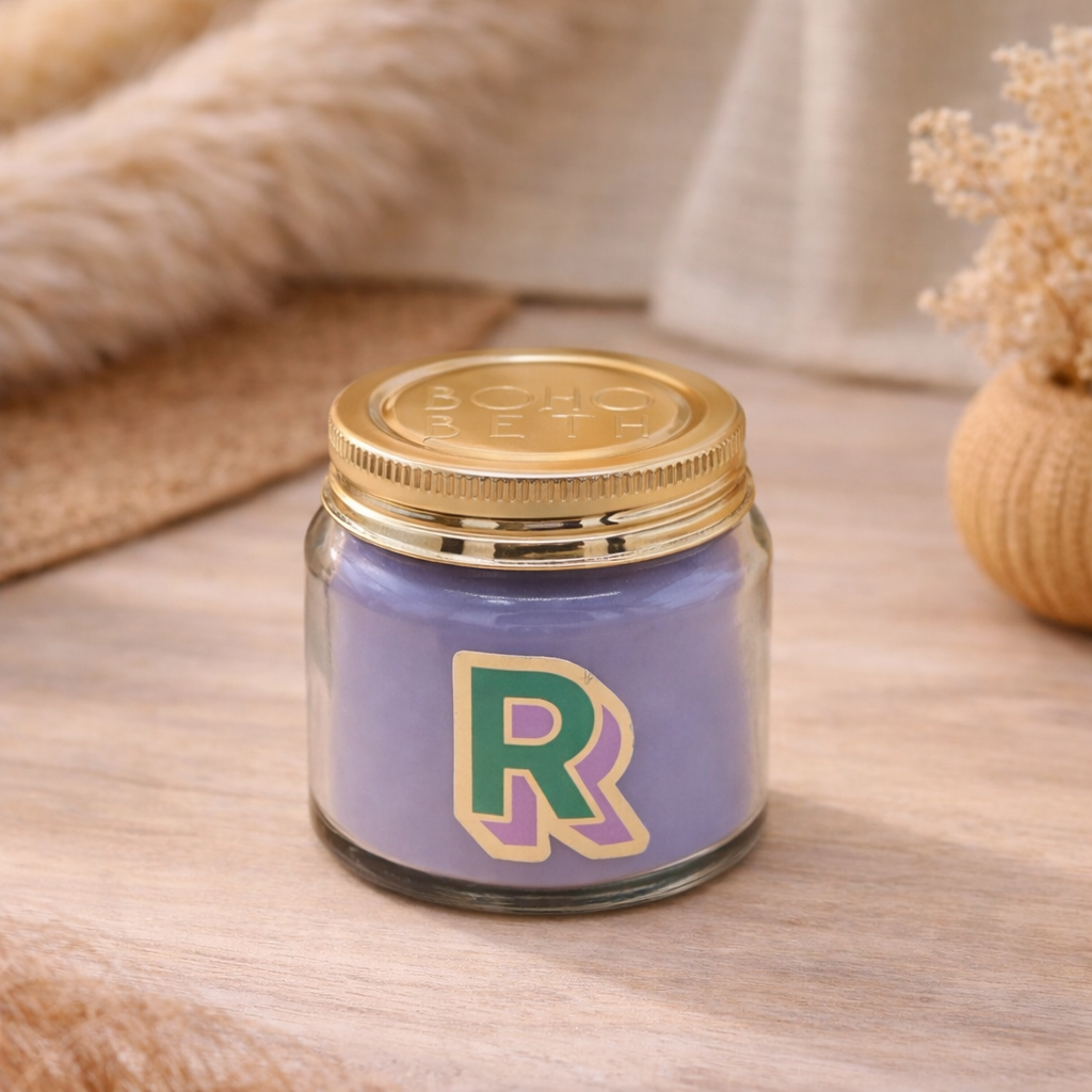 Personalised colour pop letter r candle jar with pastel wax and gold lid on bohemian background