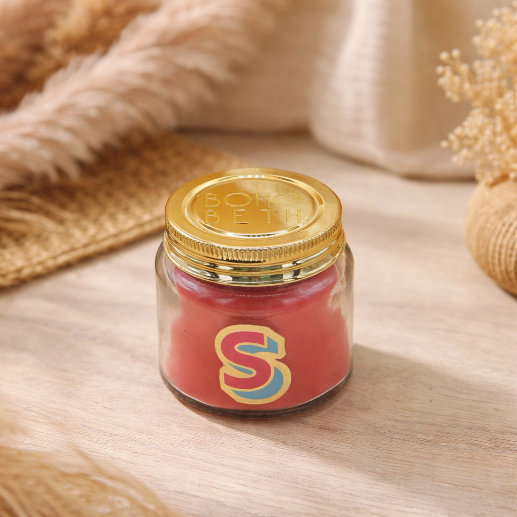 Personalised colour pop letter s candle jar with pastel wax and gold lid on bohemian background