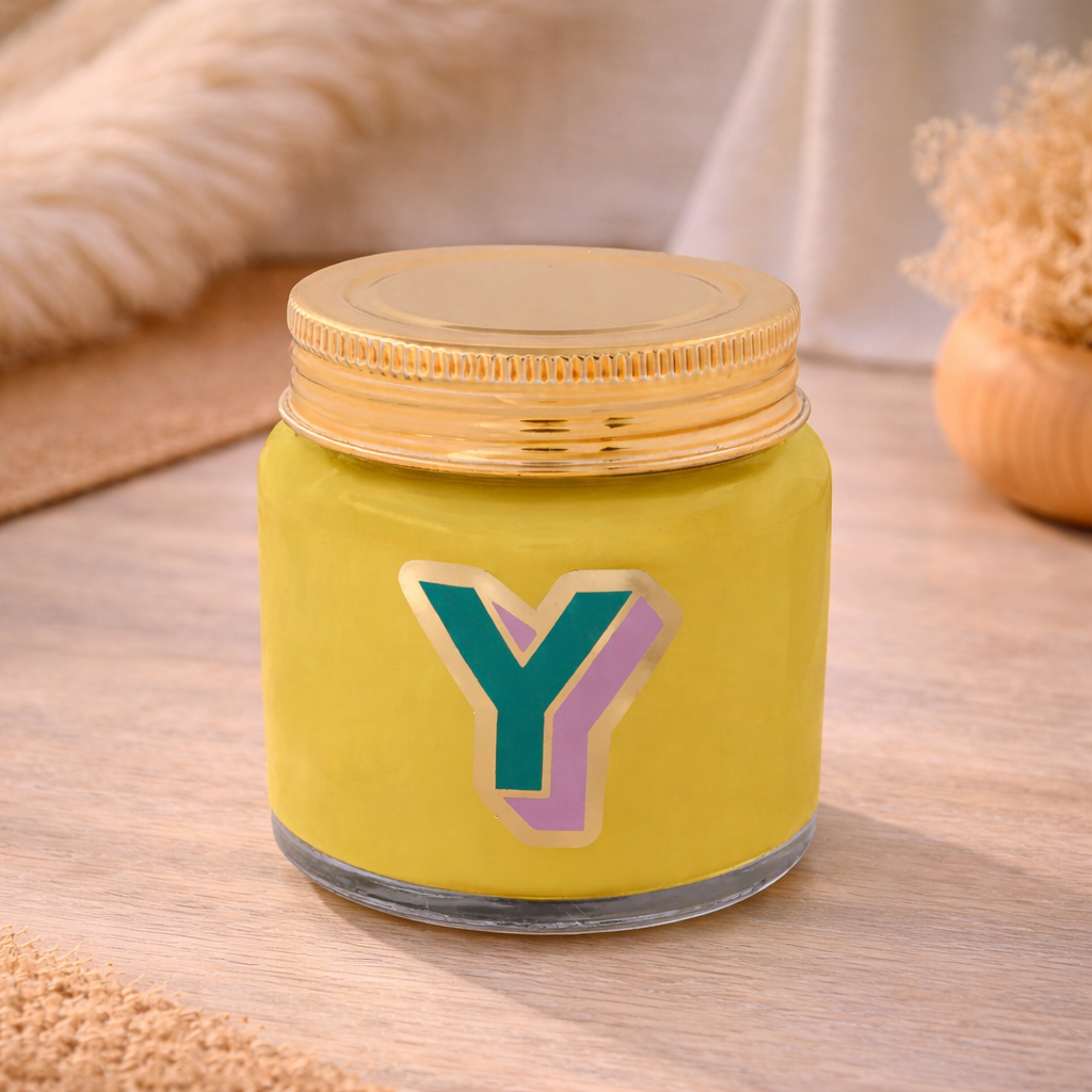 Personalised colour pop letter y candle jar with pastel wax and gold lid on bohemian background